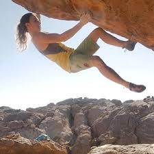 a woman stock in a bouldering attempt